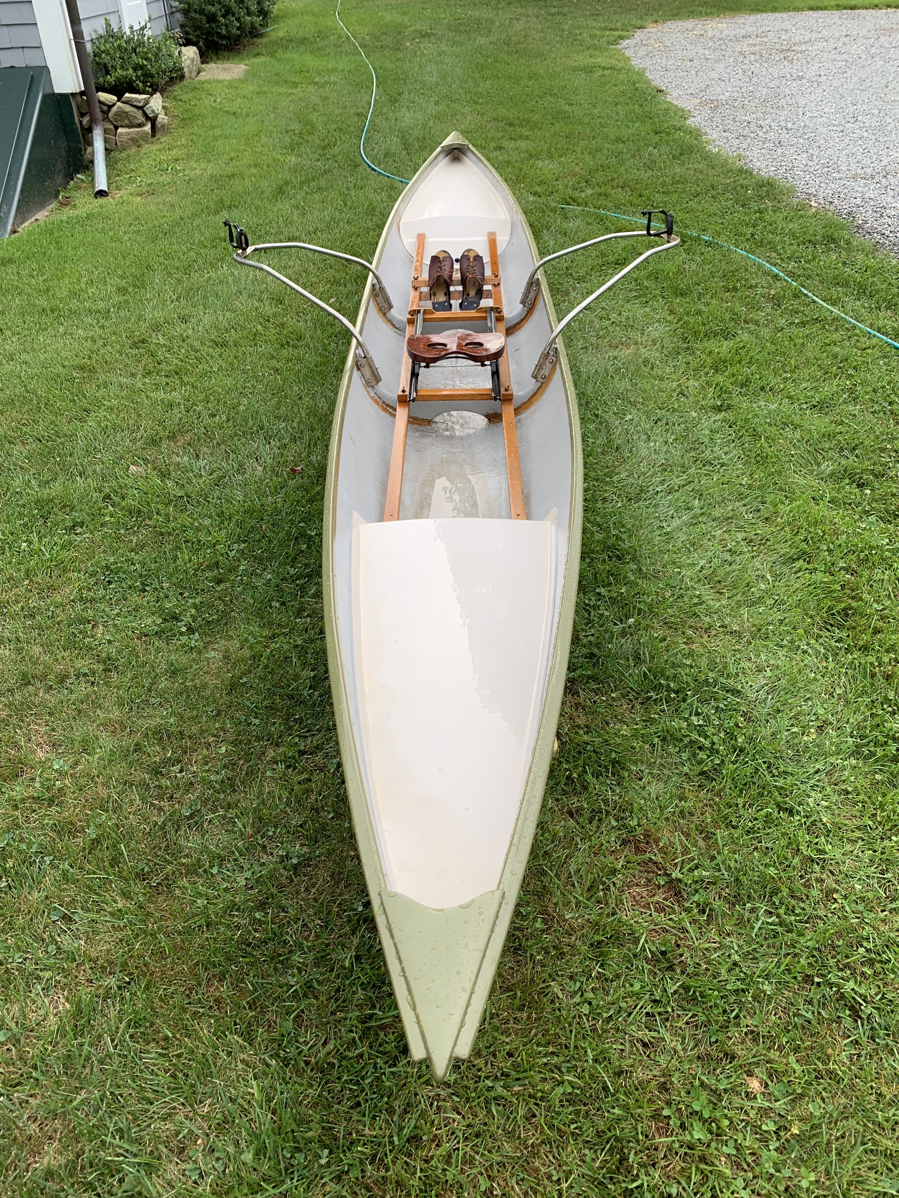 restored single person row boat with sliding seat outside