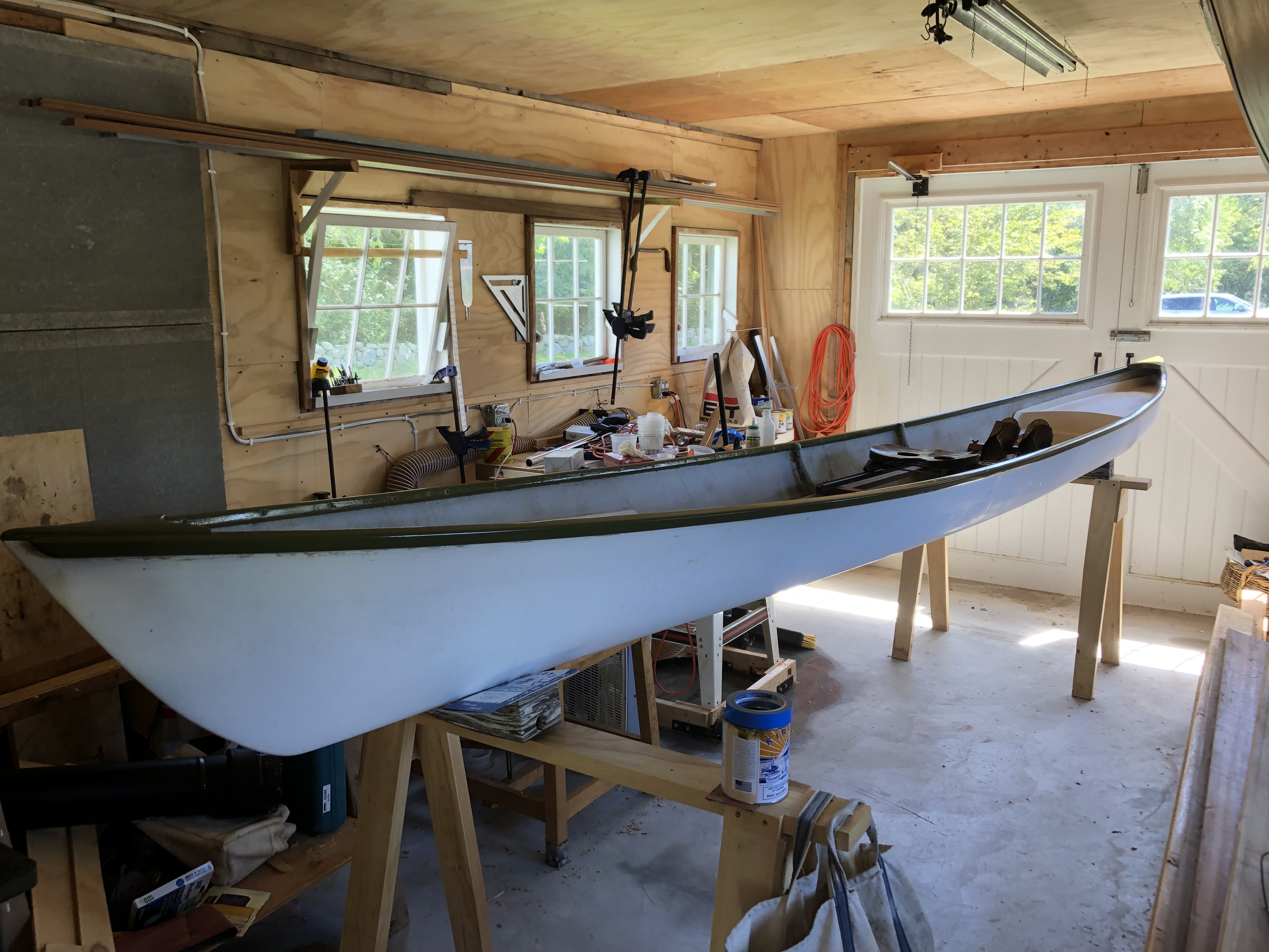 restored single person row boat with sliding seat in shop